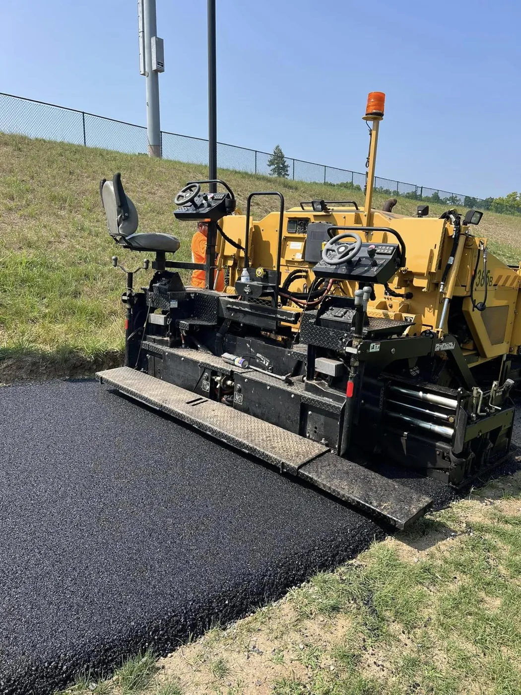 Asphalt paver machine laying a new surface