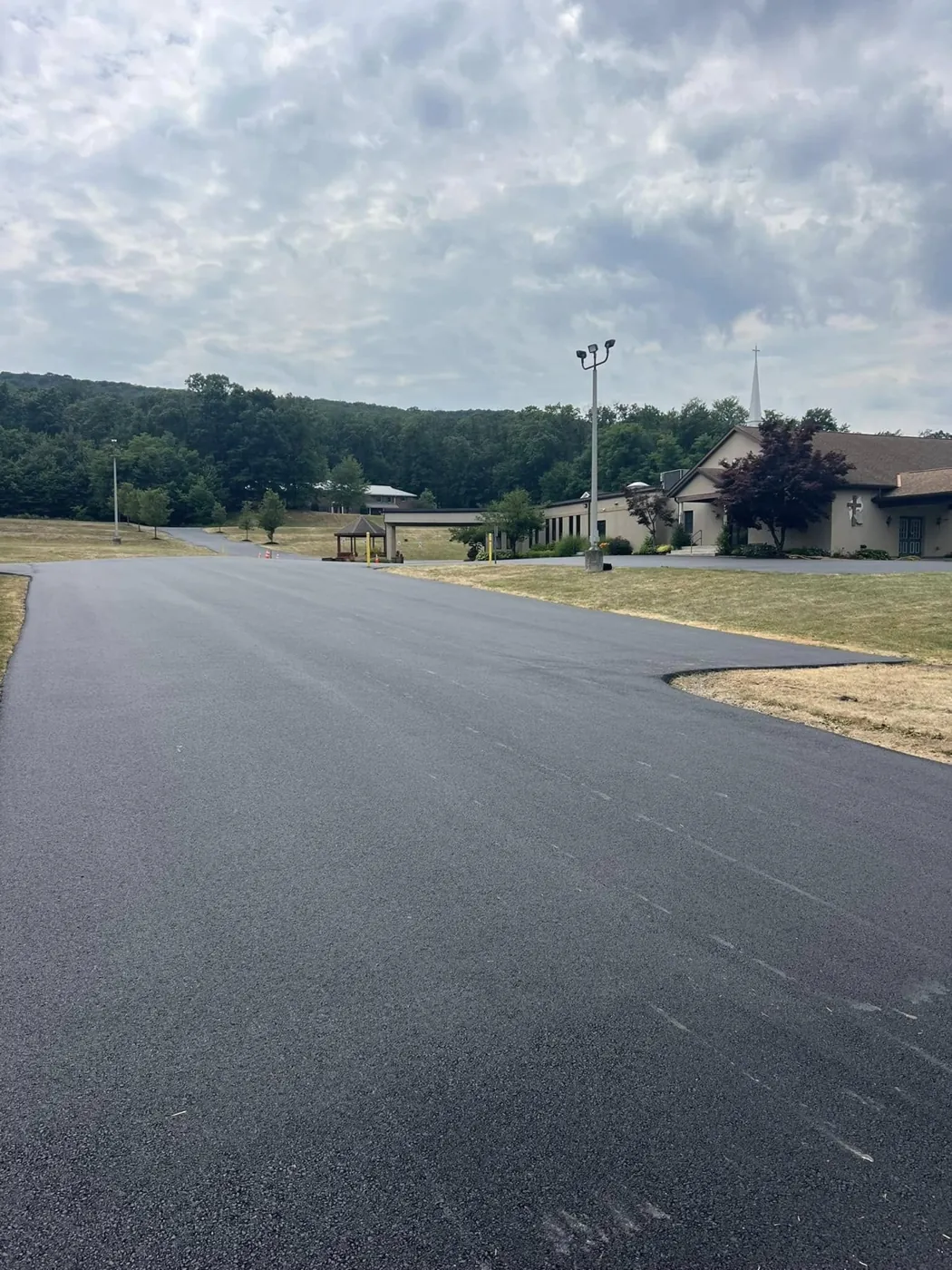 Entrance to a freshly paved commercial parking lot