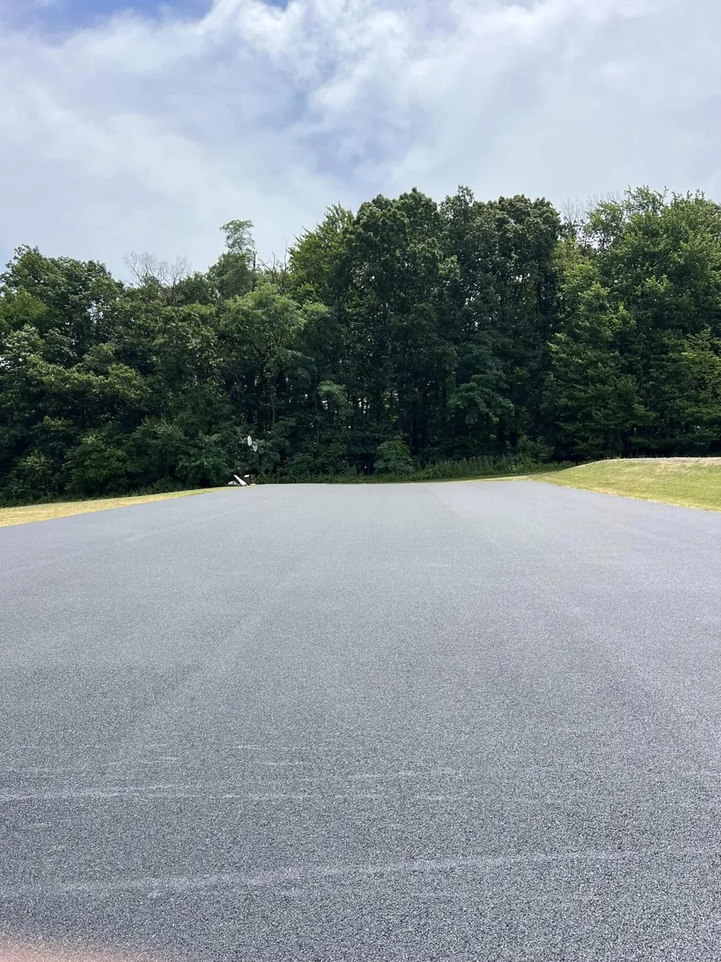 Commercial lot laid in fresh asphalt before striping