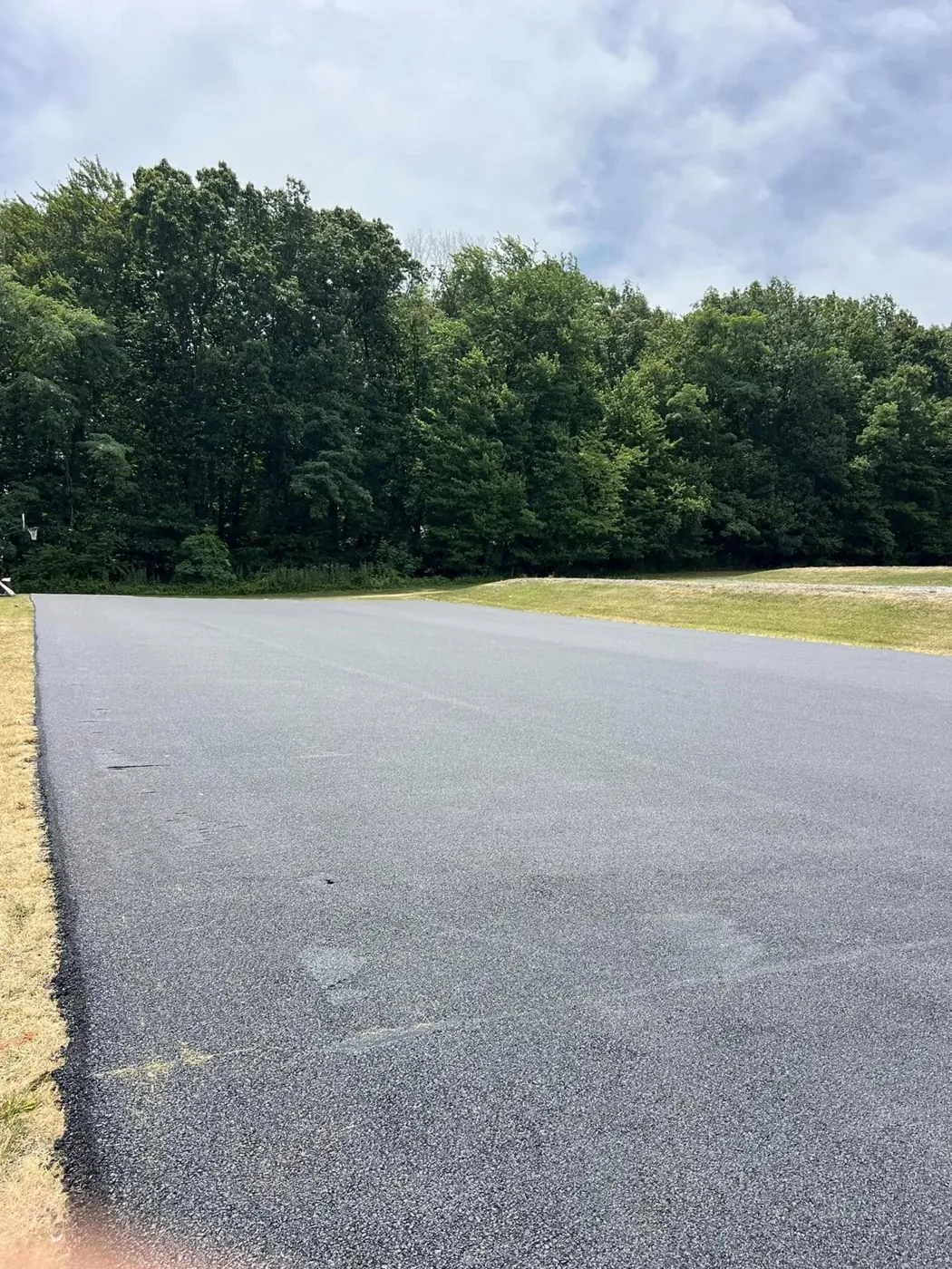 Wide commercial parking lot, newly paved