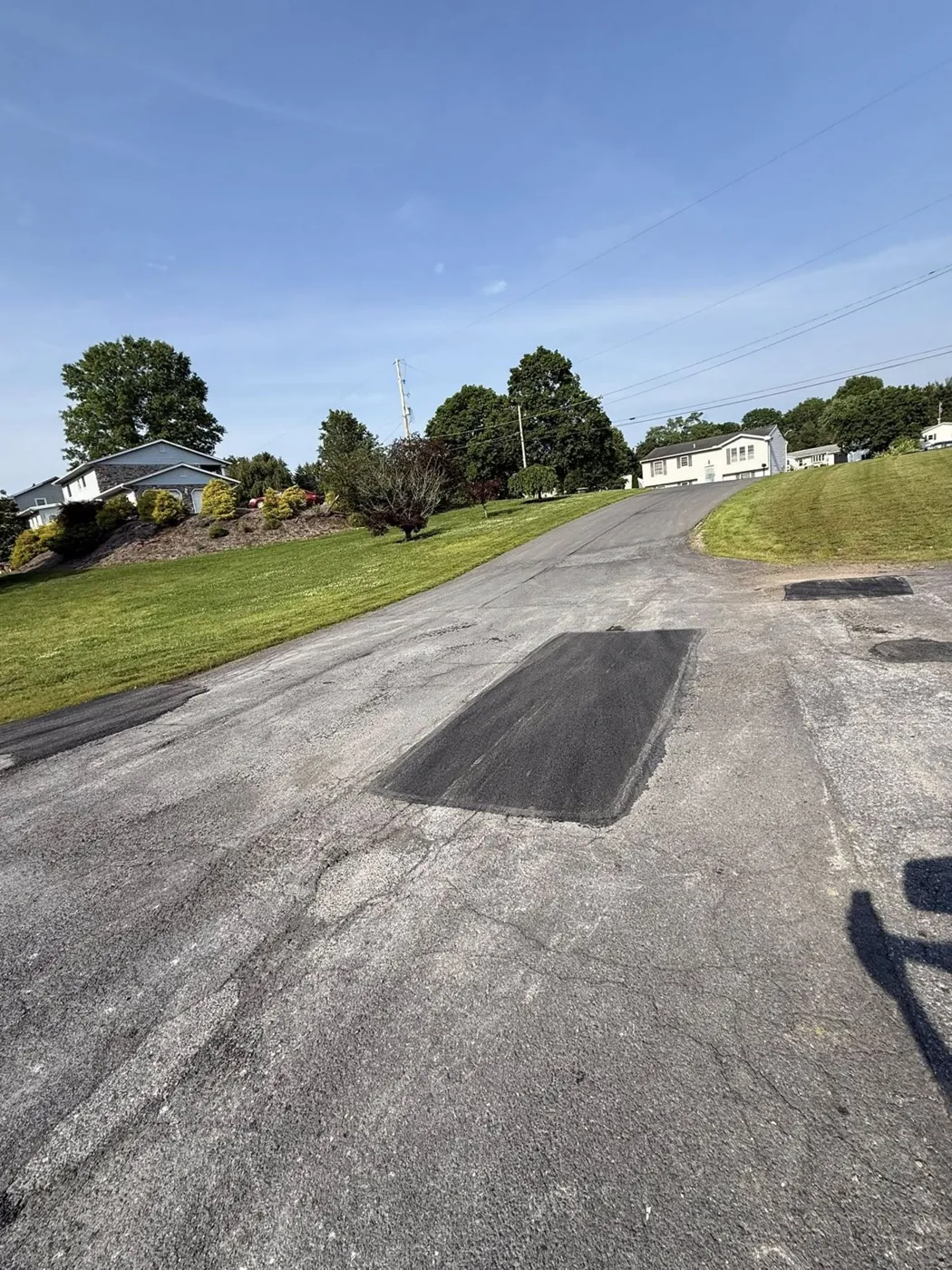 Completed asphalt patch repair in a worn surface